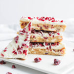Cranberry Bliss Bars; a gluten free blondie cake base with dairy free coconut and white chocolate frosting, loaded with delicious cranberries. Starbucks Bliss Bars copycat, but a healthier version!