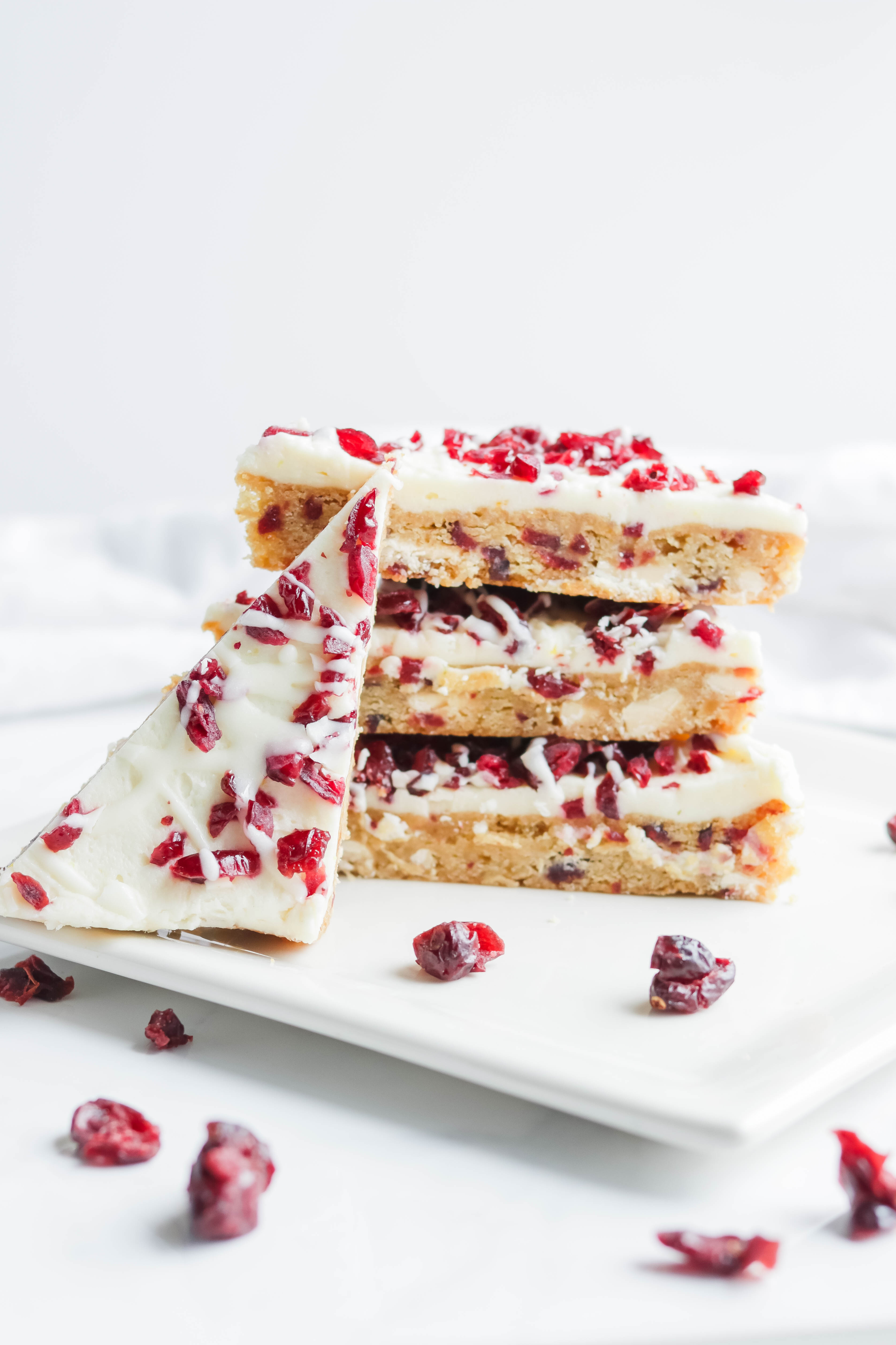 Cranberry Bliss Bars; a gluten free blondie cake base with dairy free coconut and white chocolate frosting, loaded with delicious cranberries. Starbucks Bliss Bars copycat, but a healthier version!