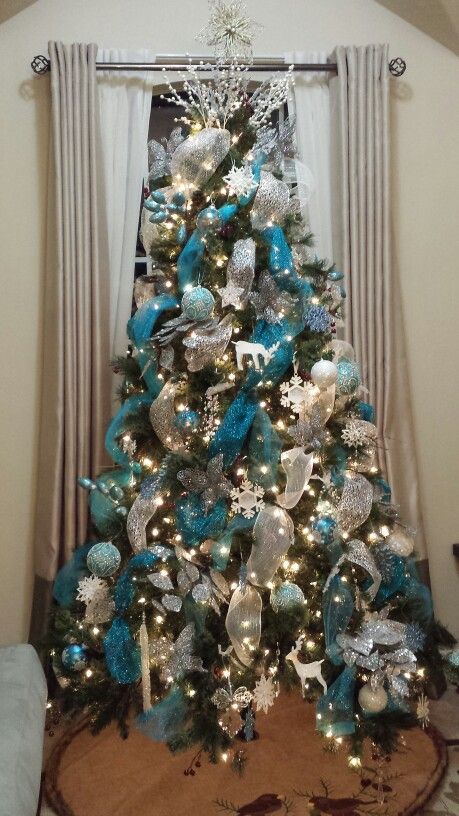 This Christmas tree uses ribbon to create a lovely color scheme. I love the bright blue ribbon with all the white pieces.