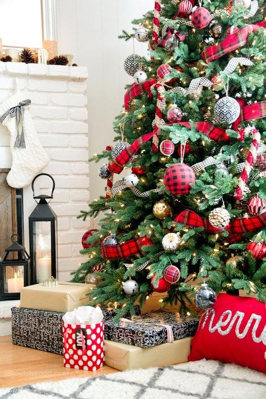 The ball ornaments on this Christmas tree are buffalo check, which matches the ribbons and other ornaments on the tree