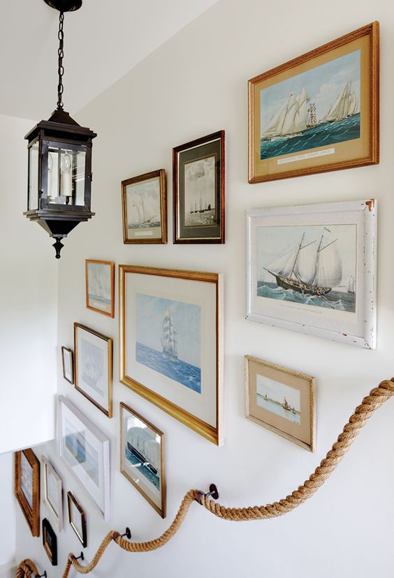 This stairway gallery wall is a collection of artwork that fits one theme. The different images, sizes, and frames really makes it an eclectic, lovely wall! 