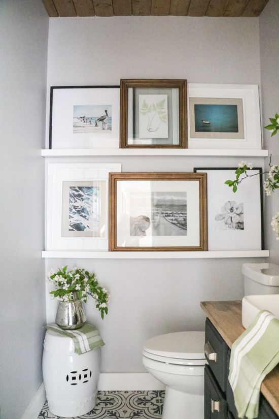 This bathroom gallery wall is a collection of beach images that are all in different frames and sizes! I love using shelves to display pictures in a gallery wall. 