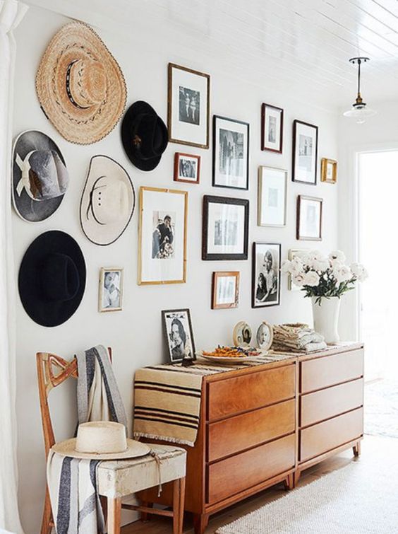 This gallery wall displays not only pictures, but hats too! This gallery wall is a great representation of family and personal style, with different picture frames and different size pictures.