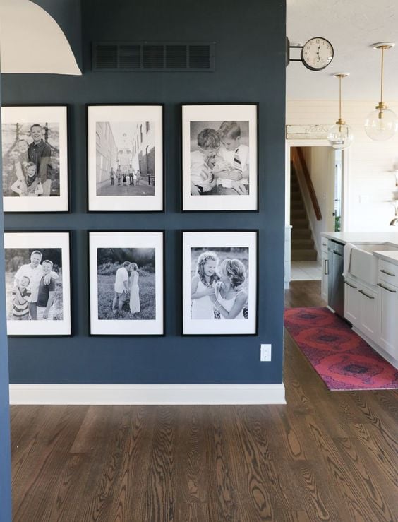 I love the black and white images in black picture frames on this gallery wall! These look like such precious family memories!