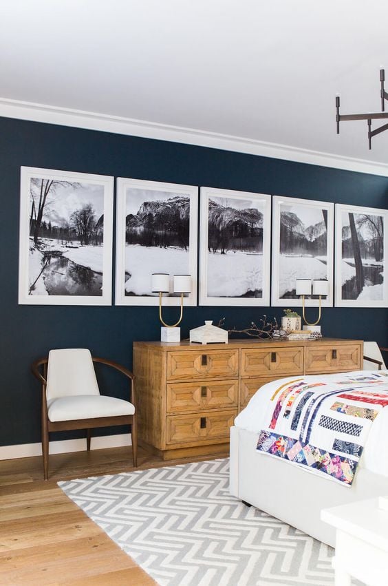 This large gallery wall is such a beautiful statement piece against the dark blue wall! I love the panoramic photography broken up into five frames