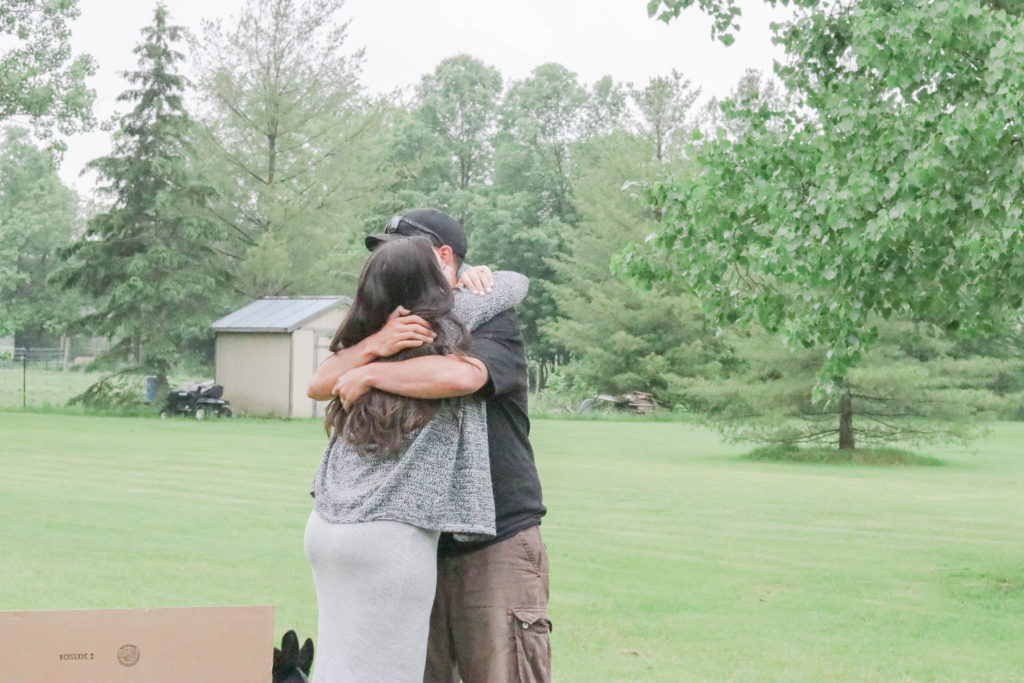 Gender Reveal Party - the mom and dad hugging after finding out their baby is going to be a girl