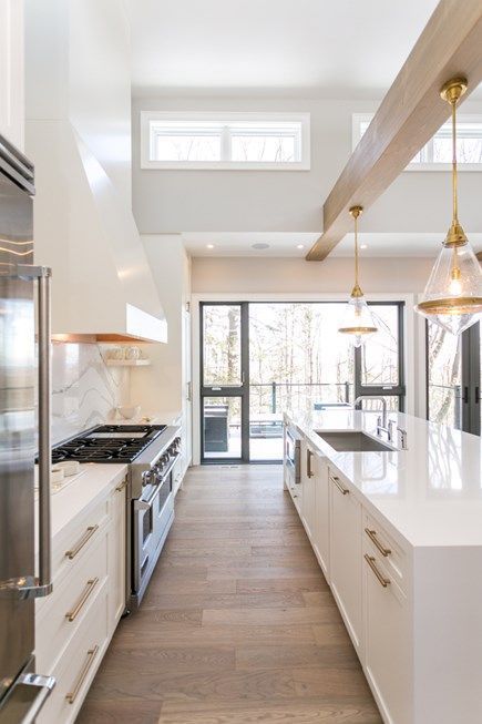 White Kitchen Designs You Haven't Seen Yet! Beautiful white kitchen inspiration for your remodel. Marble Countertop, black pendant light, island, bright white #whitekitchen #modern