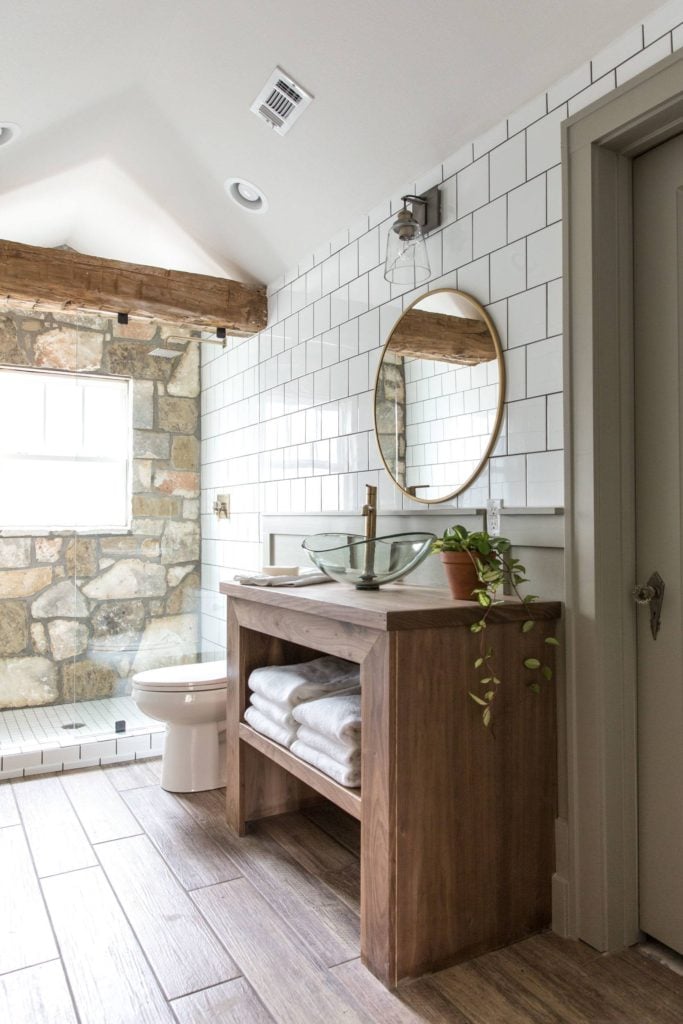 Best Bathrooms by Joanna Gaines; Fixer upper's top bathroom renovations by Joanna and chip Gaines! These rustic, country with hints of modern perfection bathrooms are everything #joannagaines #bathroom #bathrooms #renovations || Rustic Bathroom, Wood Vanity, Round Mirror - Nikki's Plate