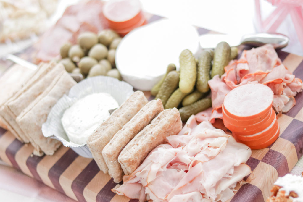 For our baby shower food, we put out an appetizer buffet that included snack boards with cheese, crackers, deli meats, and vegetables.