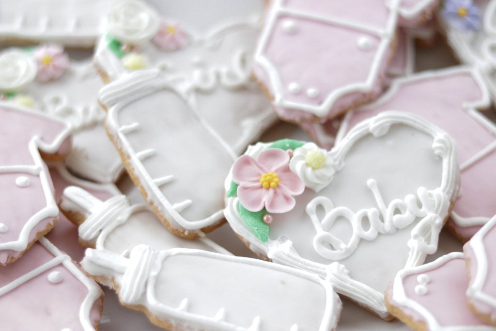 These adorable baby themed cookies were the perfect treats for out pretty in pink baby shower!