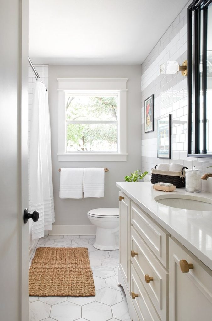 Best Bathrooms by Joanna Gaines; Fixer upper's top bathroom renovations by Joanna and chip Gaines! These rustic, country with hints of modern perfection bathrooms are everything #joannagaines #bathroom #bathrooms #renovations || White Vanity, Gray Walls, White Tile - Nikki's Plate