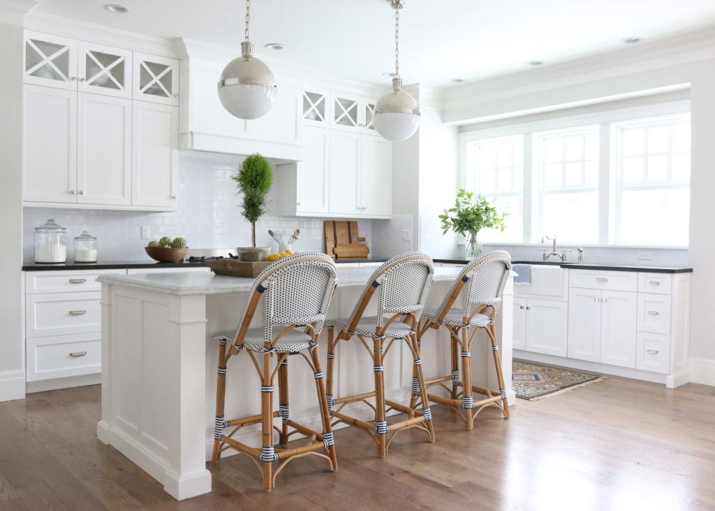 11 Best Kitchens by Studio McGee; This kitchen is small, but feels so open with bright and warm colors. I love the gray wicker bar chairs