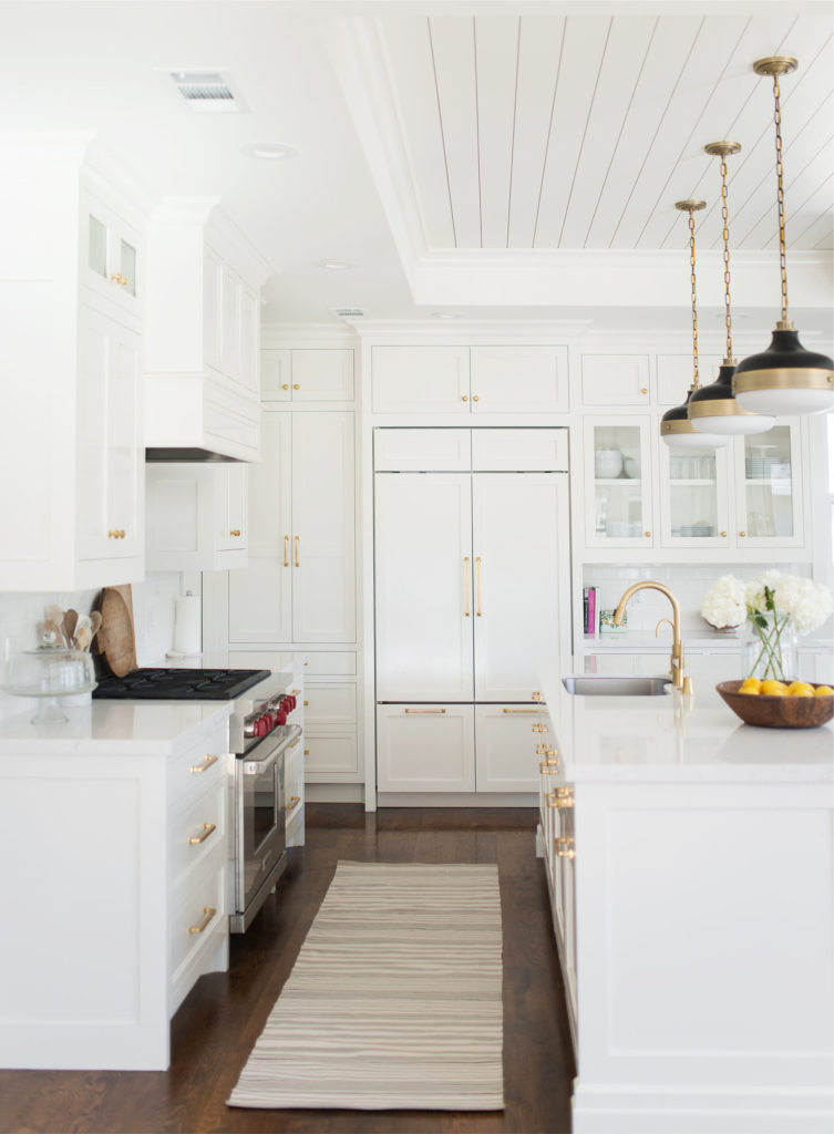 11 Best Kitchens by Studio McGee; This all-white kitchen look clean and morden. I love the gold hardware throughout the kitchen, on the sink, and the light fixtures