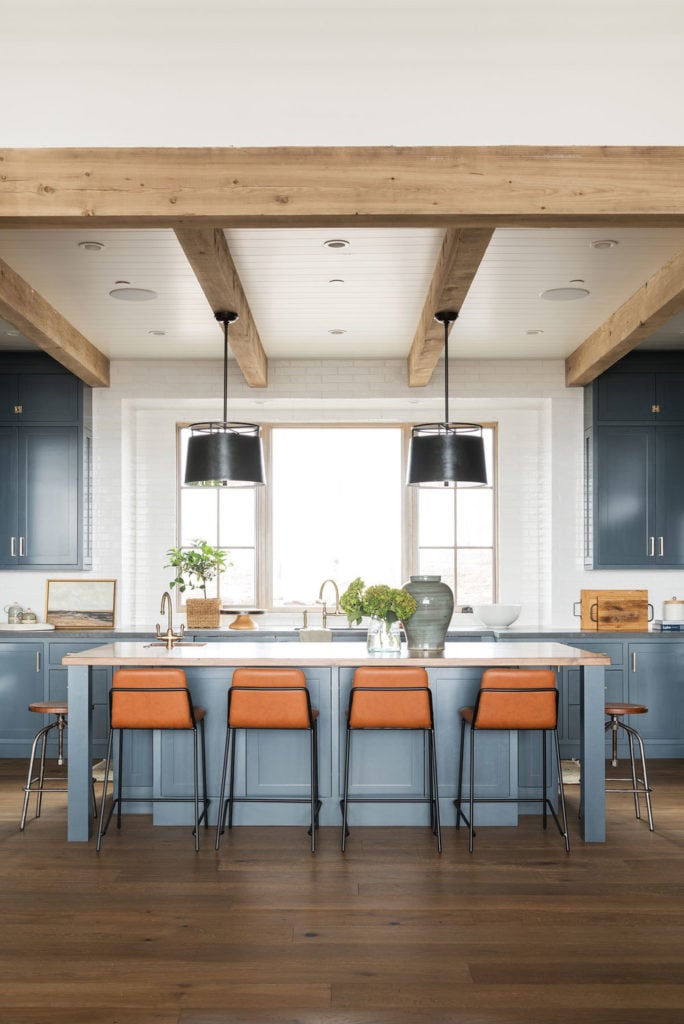 11 Best Kitchens by Studio McGee; I love the wide open, bright space of this kitchen, the cobalt blue cabinets, and the gorgeous rustic beams on the ceiling!