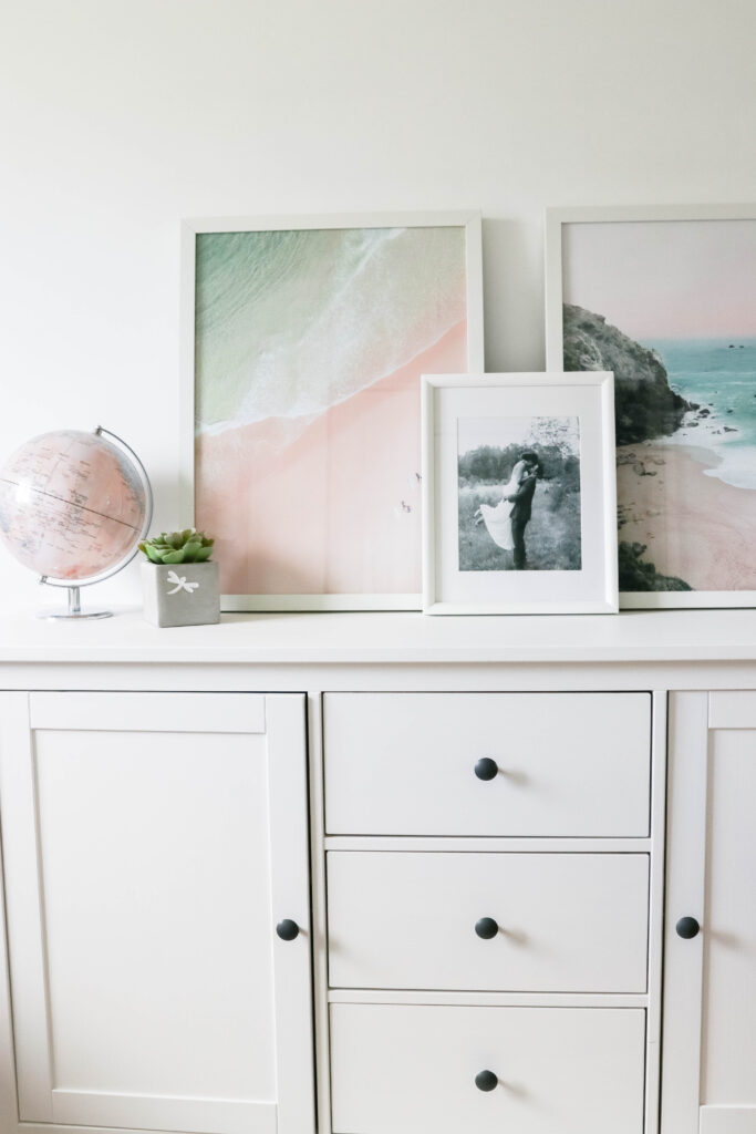 Girly White office with vintage wood chair, iMac computer, greenery, tall calendar, white vintage chair, daughter framed picture, white linen drapes || Nikki's Plate