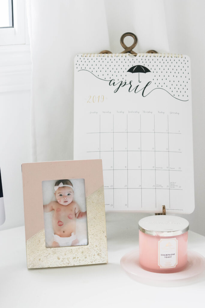 Girly White office with vintage wood chair, iMac computer, greenery, tall calendar, white vintage chair, daughter framed picture, white linen drapes || Nikki's Plate