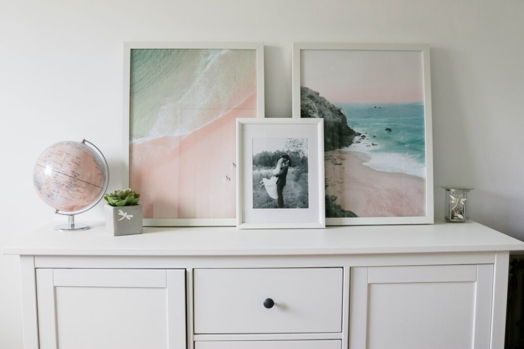 Girly White office with vintage wood chair, iMac computer, greenery, tall calendar, white vintage chair, daughter framed picture, white linen drapes || Nikki's Plate