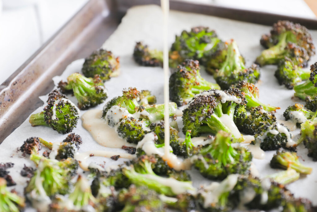 drizzling Crispy Broccoli with Vegan Cheese Sauce; dairy and gluten free side dish for your vegan dinner! A nut free cheese sauce that you will love smothered on your blackened broccoli!