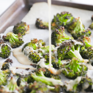 drizzling Crispy Broccoli with Vegan Cheese Sauce; dairy and gluten free side dish for your vegan dinner! A nut free cheese sauce that you will love smothered on your blackened broccoli!