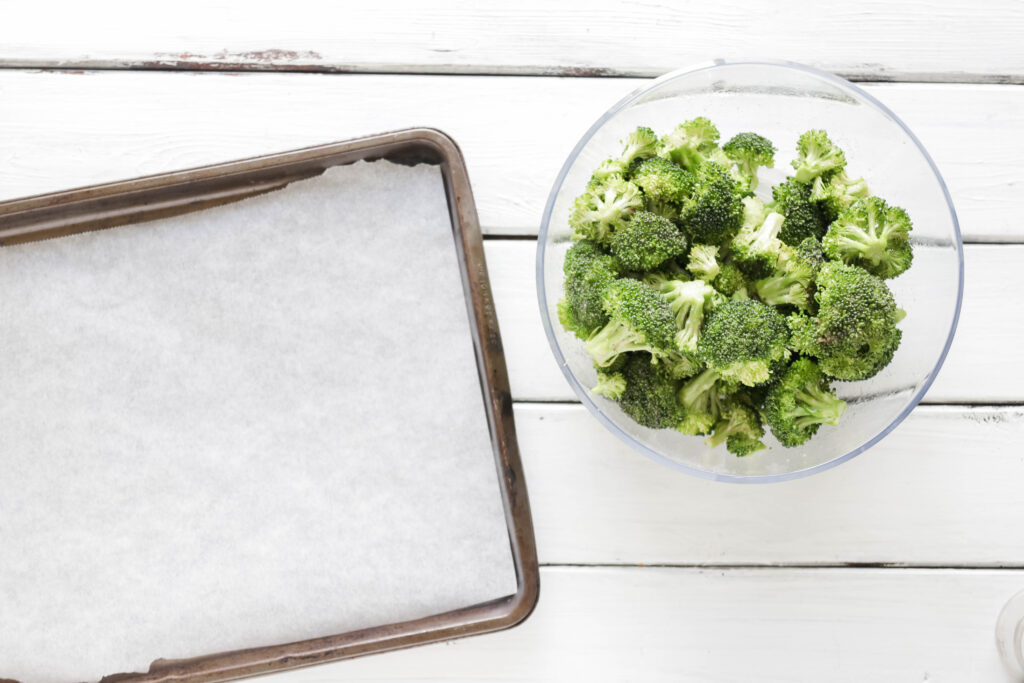 Ready to pour on pan Crispy Broccoli with Vegan Cheese Sauce; dairy and gluten free side dish for your vegan dinner! A nut free cheese sauce that you will love smothered on your blackened broccoli!