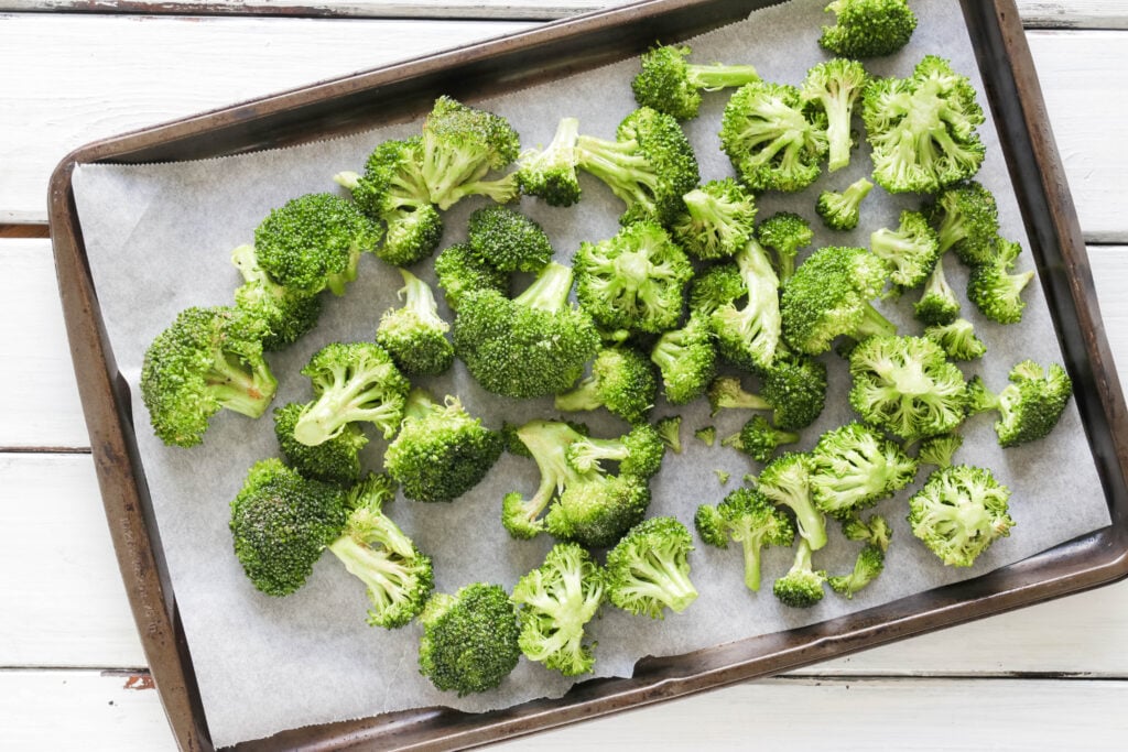 Pan of Crispy Broccoli with Vegan Cheese Sauce; dairy and gluten free side dish for your vegan dinner! A nut free cheese sauce that you will love smothered on your blackened broccoli!