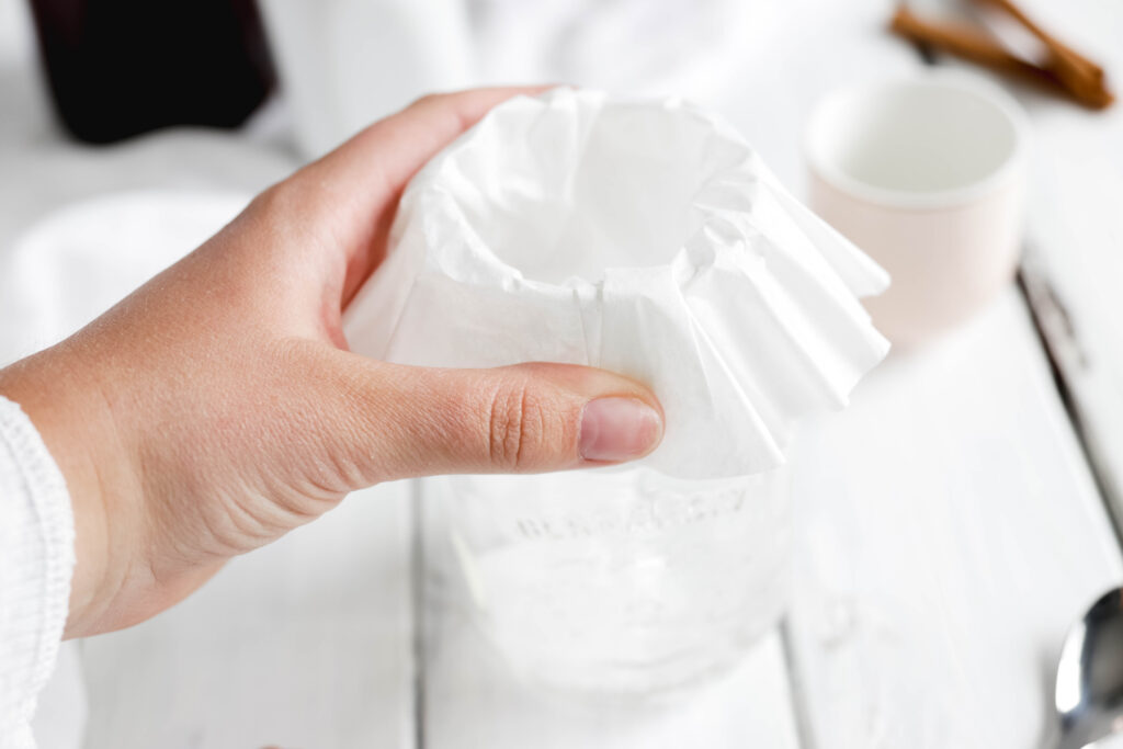 Overnight Cinnamon Cold Brew Coffee - coffee filter over mason jar , being held in place