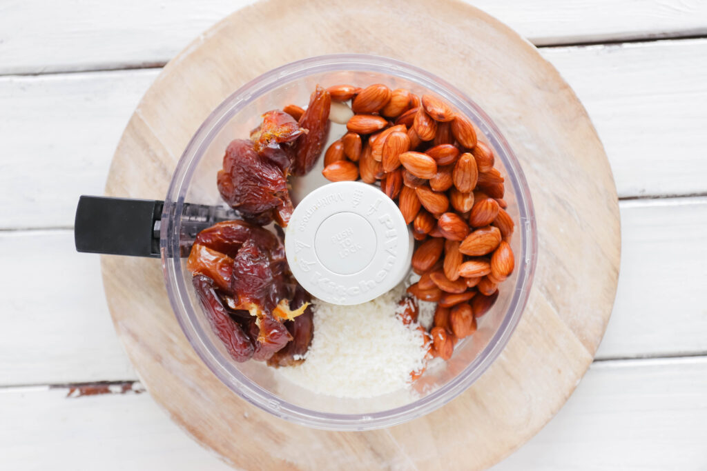 Food processor with ingredients for Chocolate Peanut Butter Ice Cream Cups; Vegan, dairy free and gluten free banana ice cream bites packed with cocoa and PB flavours.