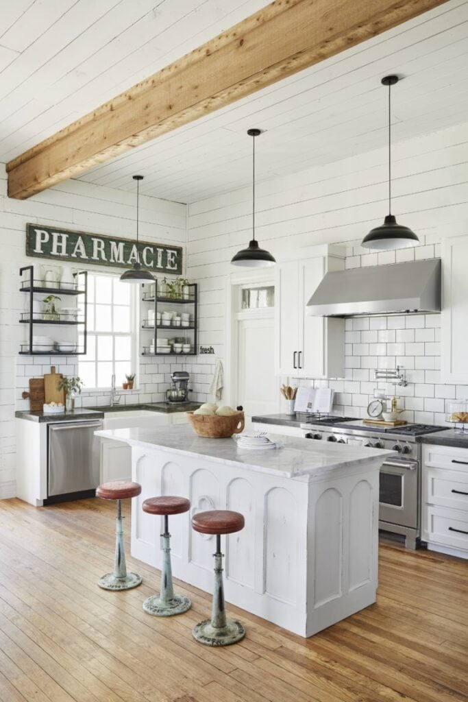 White farmhouse kitchen, shiplap kitchen, antique signs; Joanna Gaines Full Farmhouse Tour: Entire look inside Chip and Joanna Gaines's home