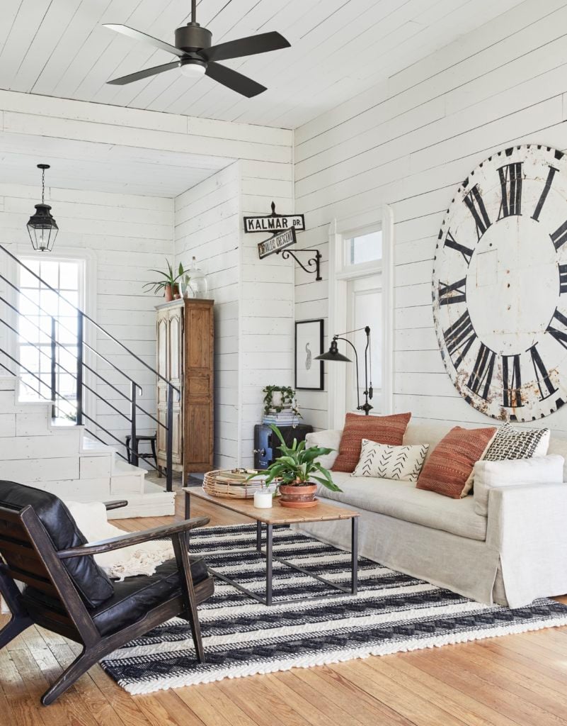 White shiplap walls, large antique clock, white couch: Joanna Gaines Full Farmhouse Tour: Entire look inside Chip and Joanna Gaines's home