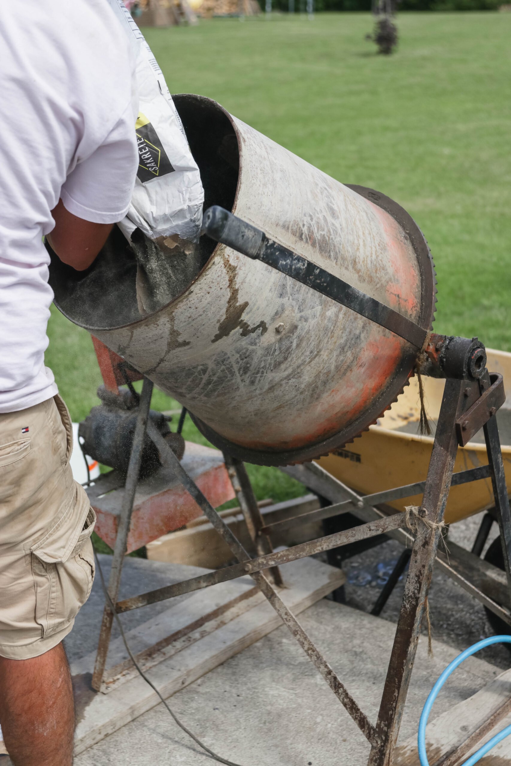 mixing concrete to pour concrete walkway