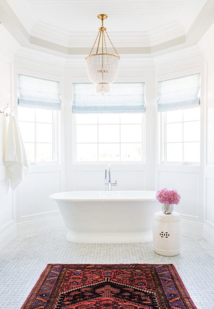 Bathrooms by Studio McGee; coastal bathroom, white tub, stand alone bathtub, chandelier