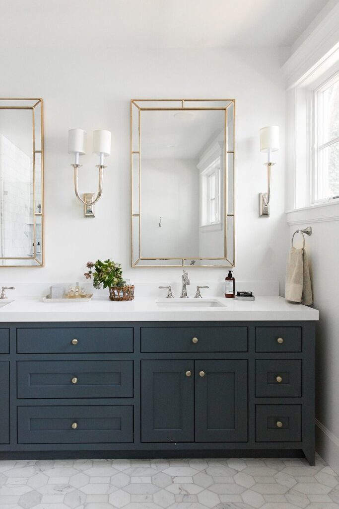 Bathrooms by Studio McGee; blue vanity, navy vanity, gold mirror, marble counter tops