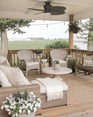 Tips for Styling your Deck this Summer; deck greenery, plants on deck, beige deck, beige outdoor furniture