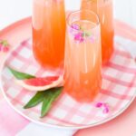 Delicious Summer Cocktail: Citrus Champagne Punch - made with orange and grapefruit juices, simple syrup, and grenadine.