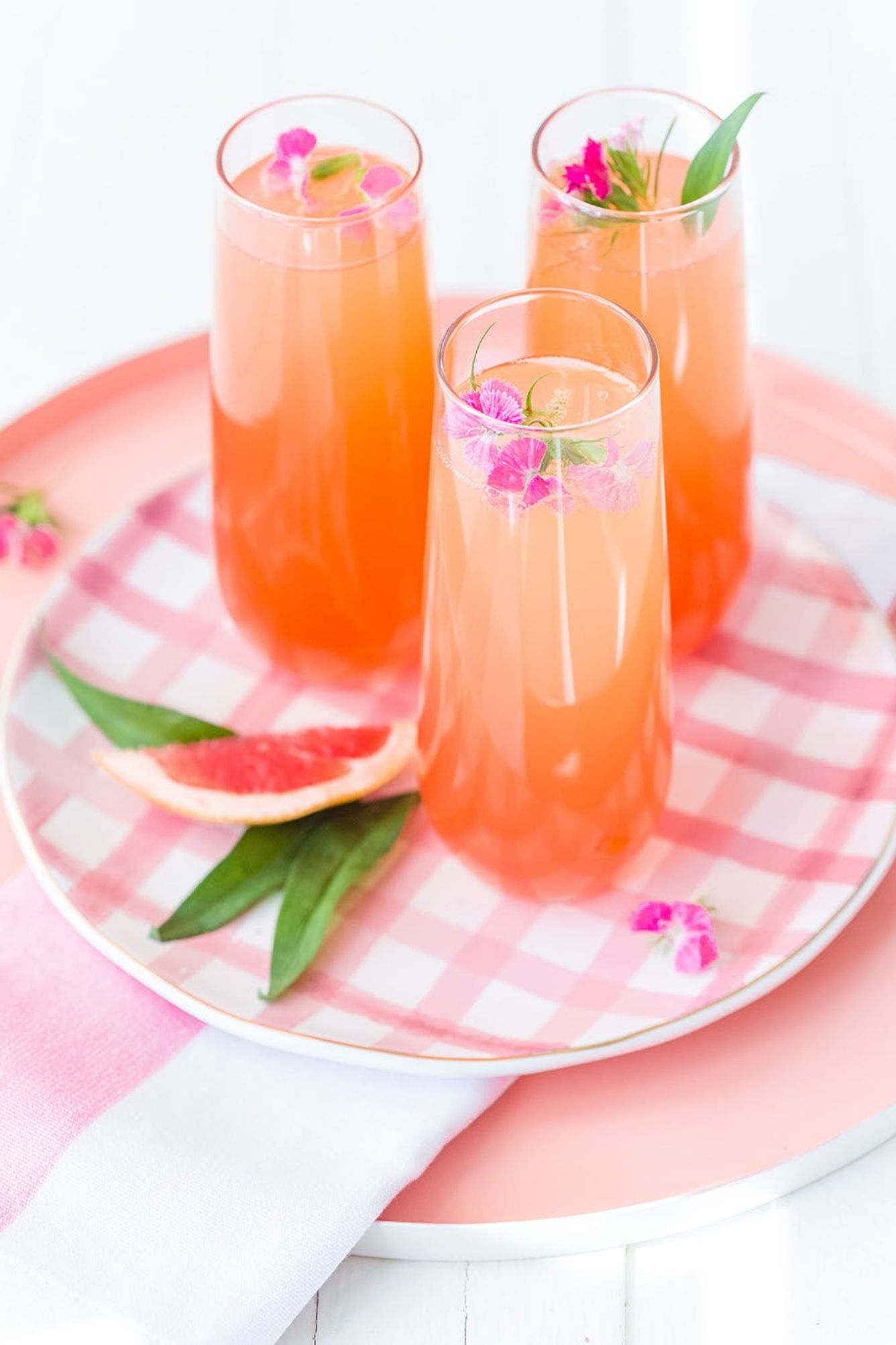 Delicious Summer Cocktail: Citrus Champagne Punch - made with orange and grapefruit juices, simple syrup, and grenadine.