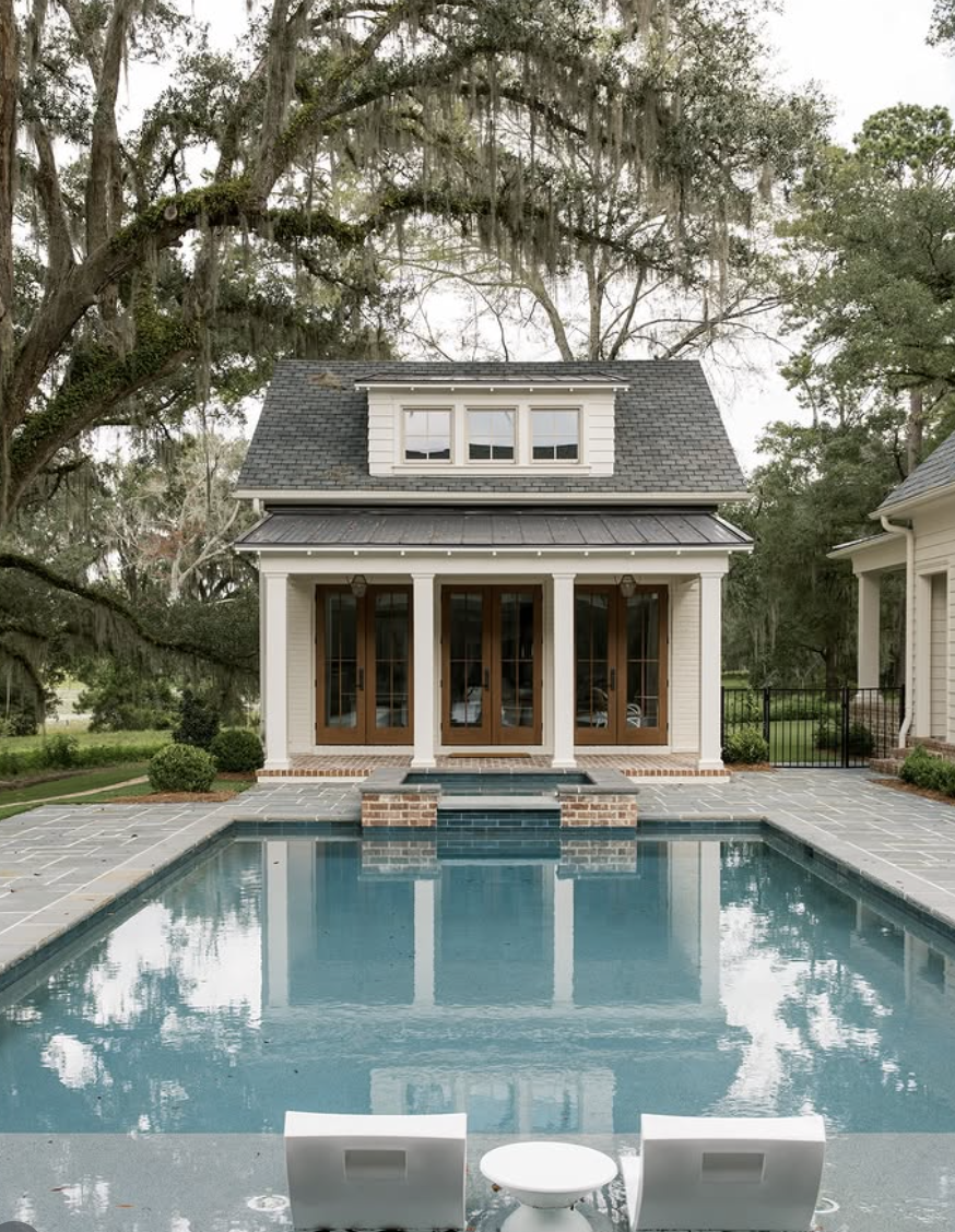 southern style pool house with french doors and rectangular backyard swimming pool