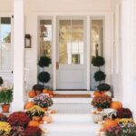 7 Fall Porch Decor Must Haves; blue door, mums, flowers