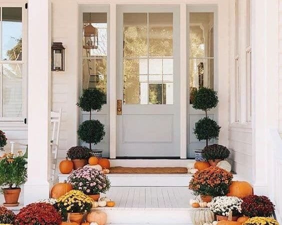 7 Fall Porch Decor Must Haves; blue door, mums, flowers