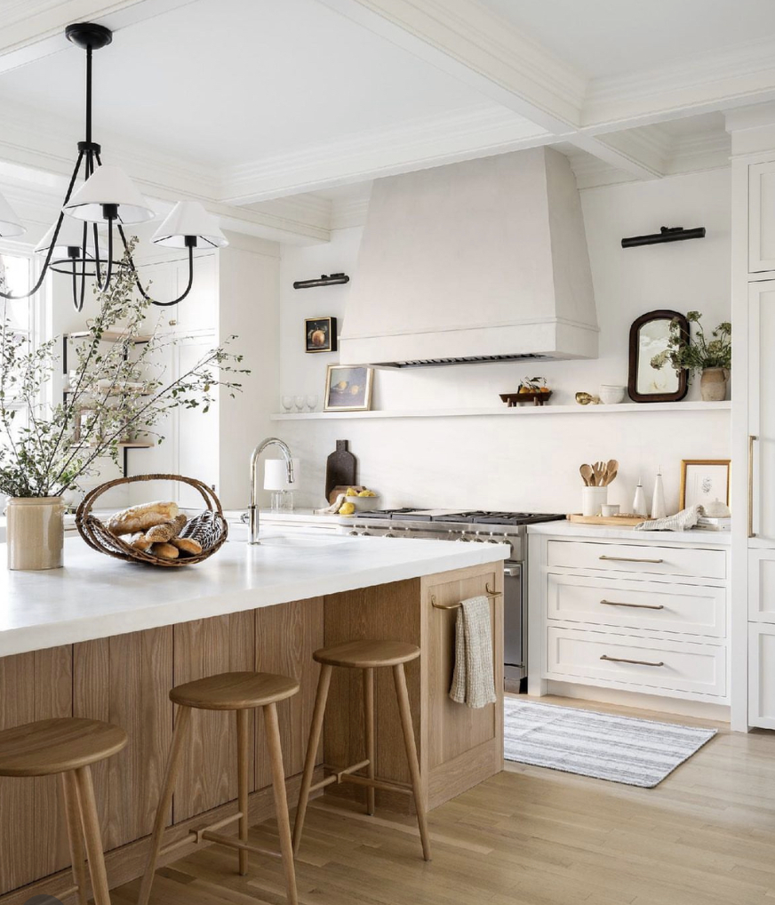 white oak kitchen with wood island, white cabinets, and minimalist design