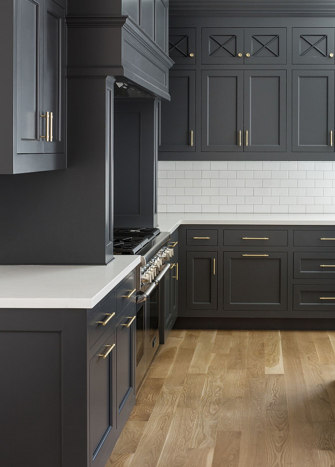 dark grey kitchen cabinets, black kitchen cabinets, white countertop, subway tile