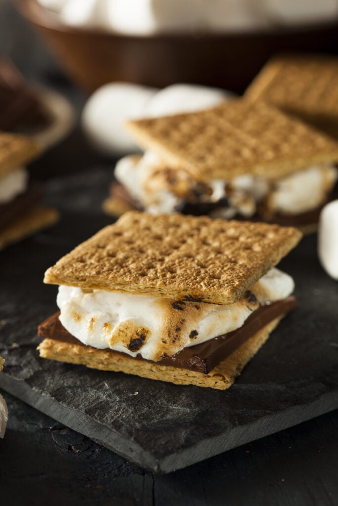 Homemade S'mores with Marshmallows Chocolate and Graham Crackers - 10 Easy Campfire Recipes (Be the Master of Campfire Cooking); Here are 10 campfire cooking recipes to try this summer!