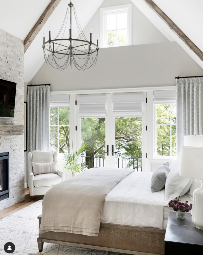 How to Style a Queen Bed - stone fireplace in bedroom, vaulted ceiling