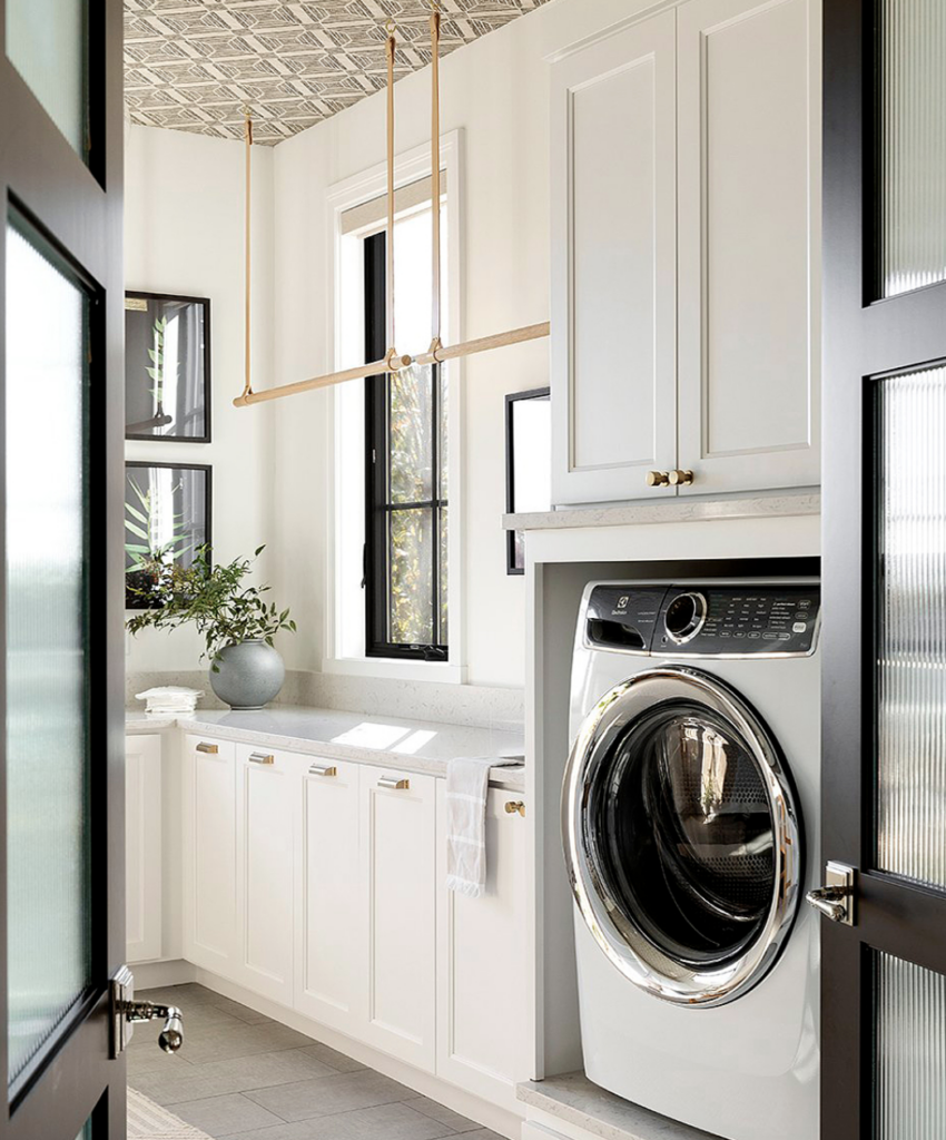 15 Laundry Room Essentials Every Homeowner Needs - white cabinets, hanging line for clothes in laundry room