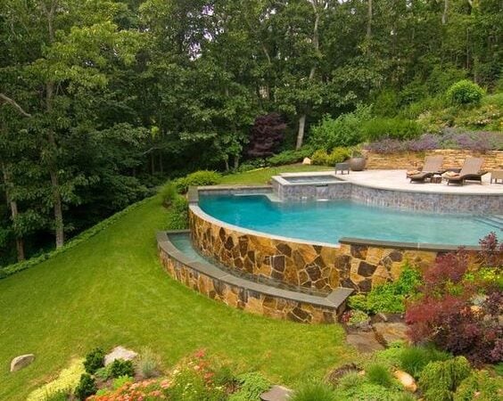 Beautiful Hillside Pool Ideas with Retaining Walls; pools on hill design with masonry stone retraining wall ideas.