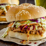 Spicy Pulled Pork Sandwiches Recipe; Homemade BBQ sauce with this pork shoulder for fall off the bone perfection! Great for lunch or dinner.