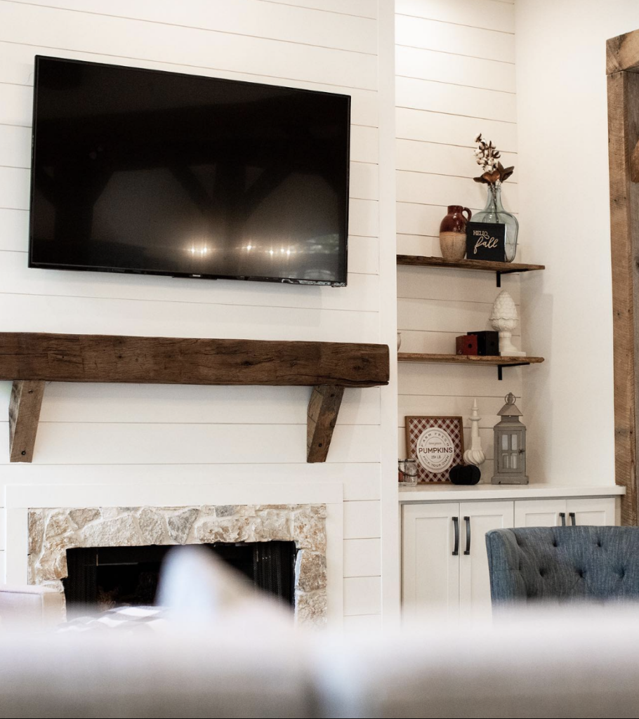 white shiplap on fireplace with mantel and tv