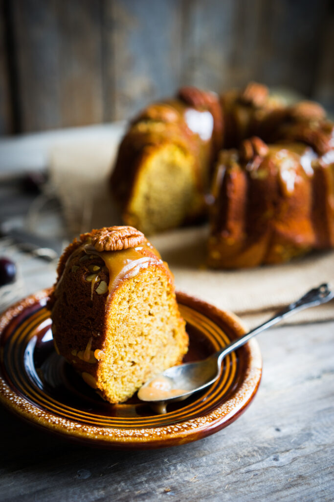 Pumpkin Apple Bundt Cake Recipe With Caramel Glaze; This delicious autumn bundt cake dessert is loaded with pumpkin spice, apples, pecans and drizzled with caramel glaze.