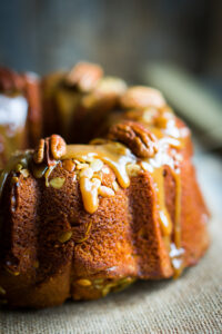 Pumpkin Apple Bundt Cake Recipe With Caramel Glaze; This delicious autumn bundt cake dessert is loaded with pumpkin spice, apples, pecans and drizzled with caramel glaze.
