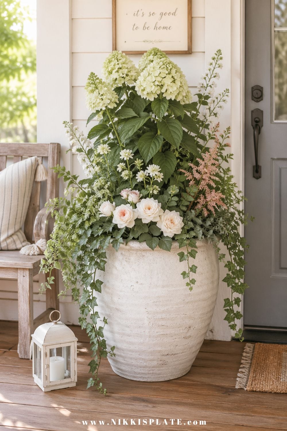 front porch planter ideas with hydrangeas, roses, and trailing ivy in a large white planter by a front door