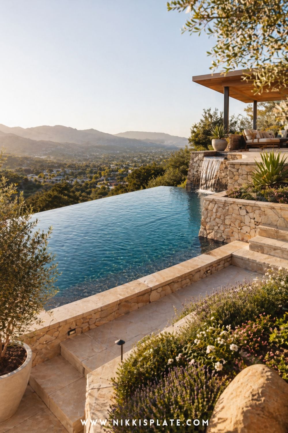 Hillside pool with retaining walls featuring a tiered infinity edge and waterfall overlooking a scenic valley